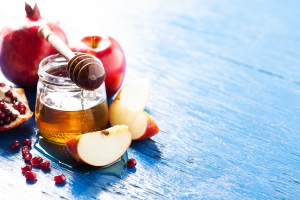 Rosh hashanah (jewish holiday) concept: honey, apple and pomegranate, with space for textRosh hashanah (jewish holiday) concept: honey, apple and pomegranateRosh hashanah (jewish holiday) concept: honey, apple and pomegranate